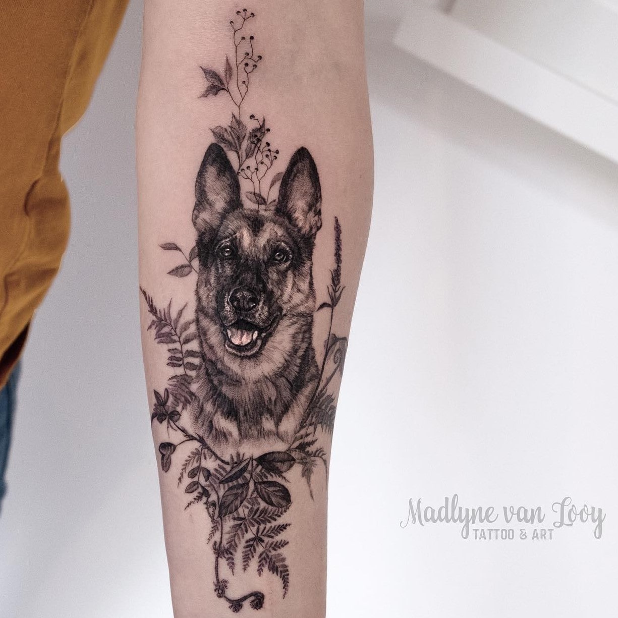 Black and grey German Shepherd tattoo on the calf