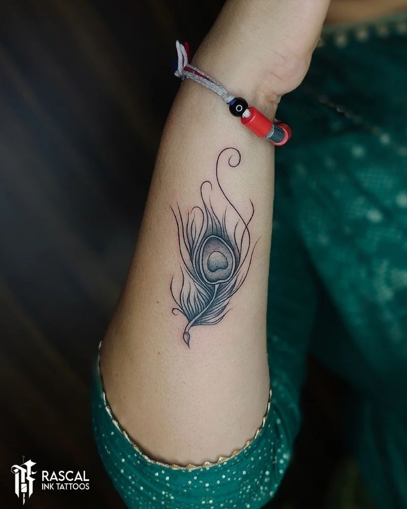 Ansh Ink Tattoos  Feather Tattoo Design  Krishna Tattoo  Wrist Tattoo  Design for Girls  Flute and Feather Tattoo   Follow on Instagram    httpswwwinstagramcomanshinktattoos    