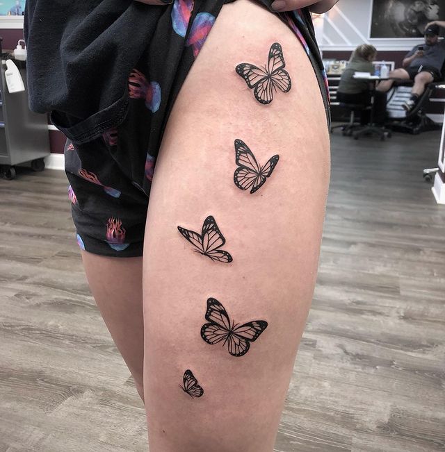 Black butterfly thigh tattoos