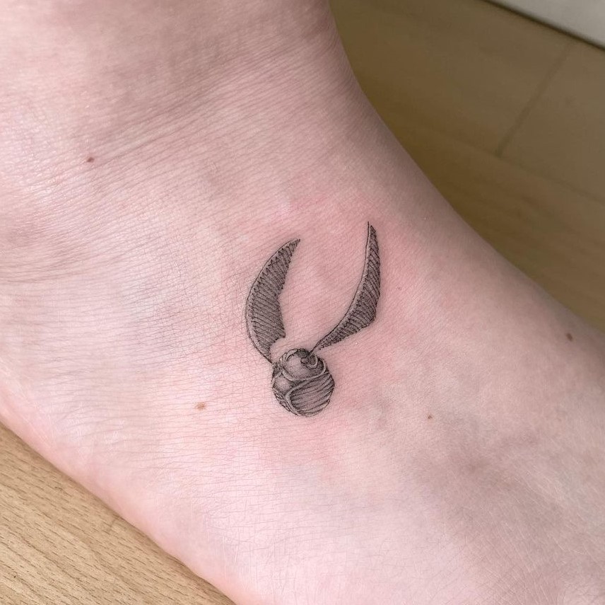 golden snitch tattoo ankle