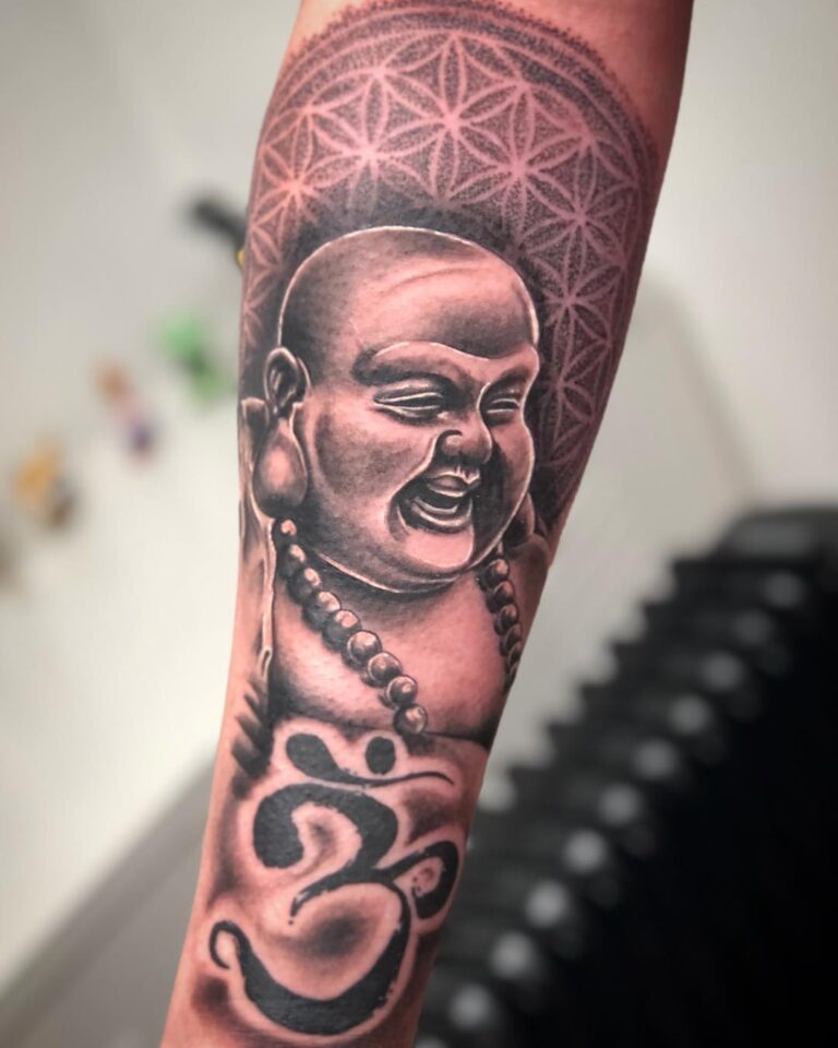 40 Best Laughing Buddha Tattoo Ideas November 2024   Laughing Buddha With Om Symbol Forearm Tattoo Spiritual Harmony And Universal Consciousness 768x960 