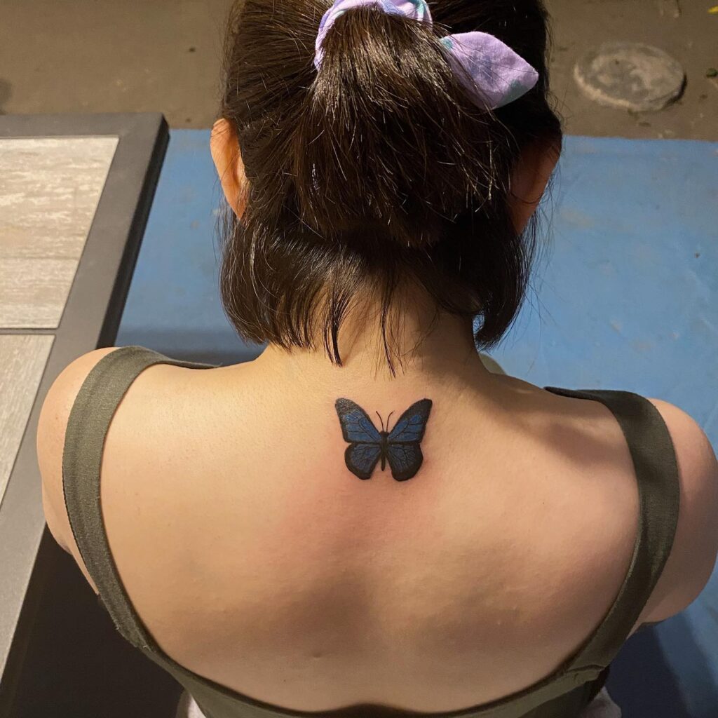Blue black butterfly neck tattoo female