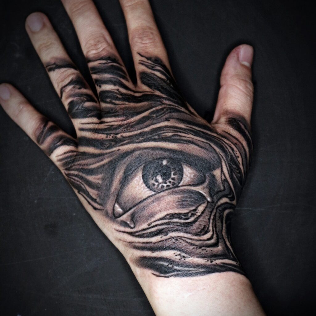 hand with eye tattoo
