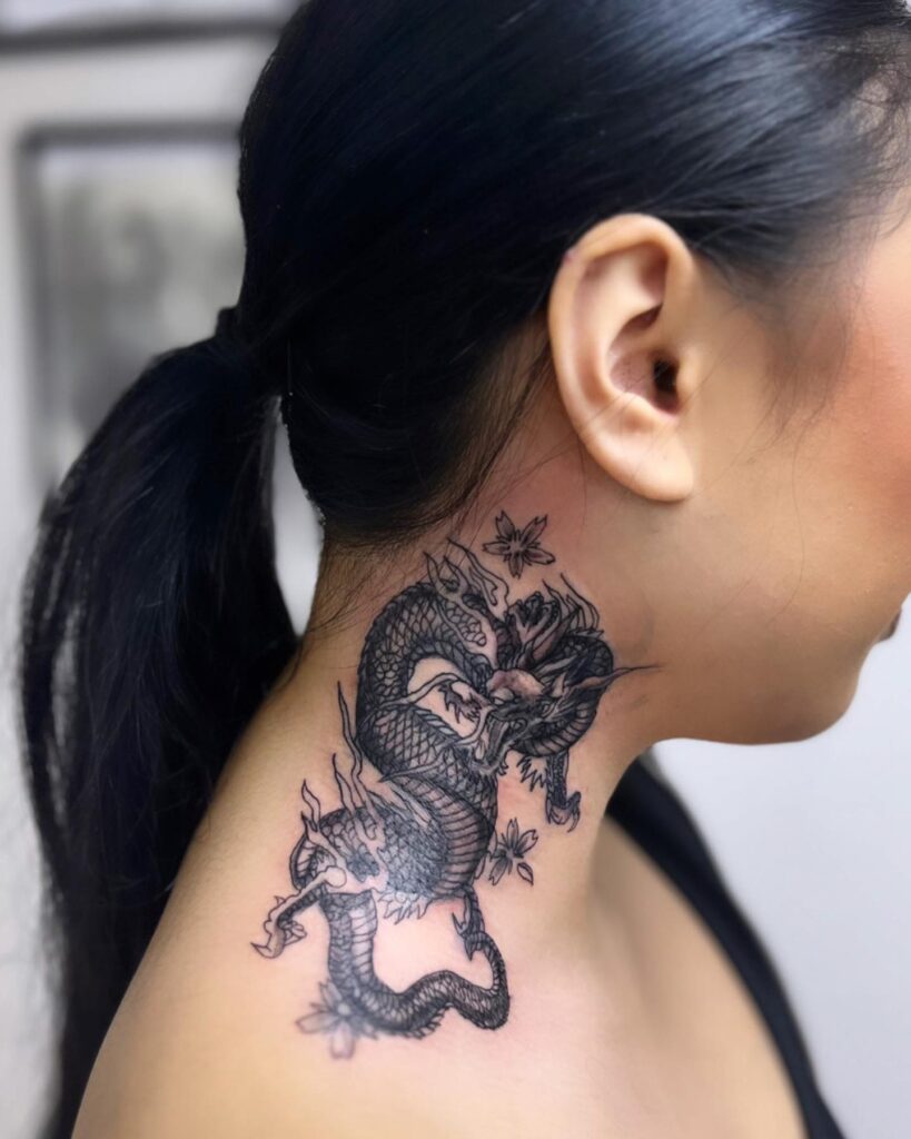 Tattoo of a red dragon done on the back of the neck.