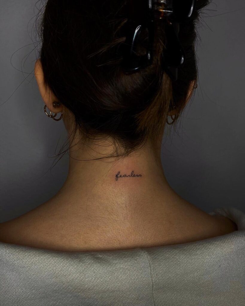 Delightful script lettering on the back of the neck, a cute and clean expression "fearless" whispers
