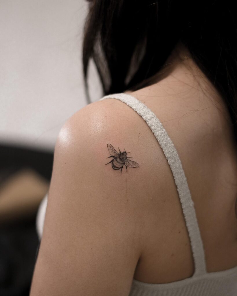 Micro bee tattoo on the back shoulder skipper
